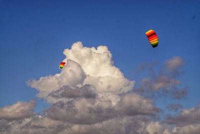 Low angle view of paragliding against sky