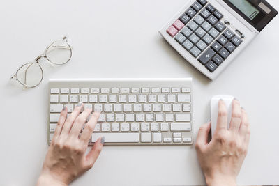 Directly above view of person using laptop on table