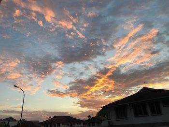 Low angle view of silhouette buildings against sky during sunset