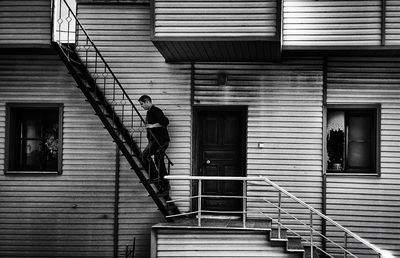 Man climbing steps against house
