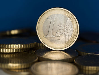 Close-up of coins against blue background