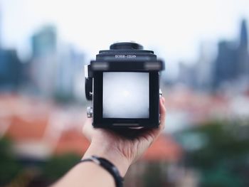 Cropped image of woman holding vintage camera