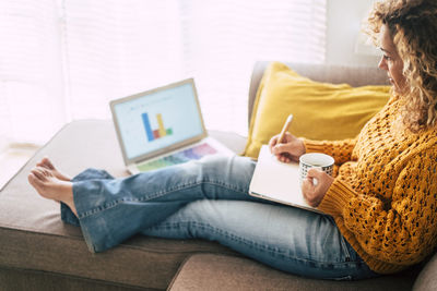 Woman using mobile phone at home