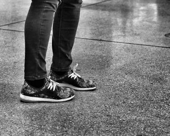 Low section of man standing on ground