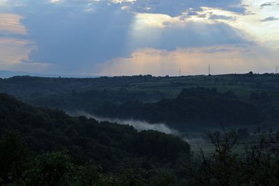 Scenic view of landscape against sky at sunset