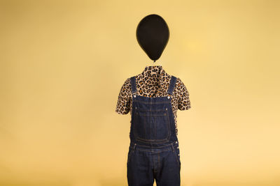 Surreal image of a mannequin with a balloon on his head