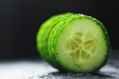 Close-up of lemon on table against black background