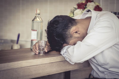 Close-up of man with drink on table