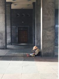 Man sitting in front of building