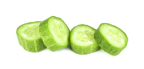 Close-up of green fruits against white background