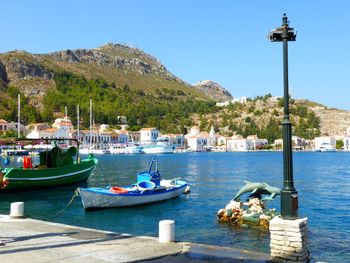 Boats in river with mountain in background