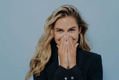 Portrait of young woman against white background