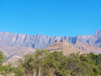 Scenic view of mountains against clear blue sky