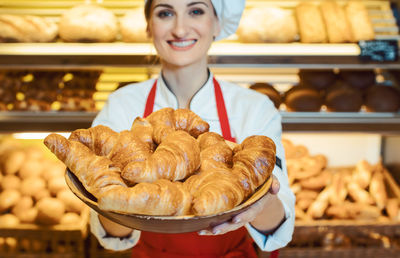 Portrait of smiling girl holding ice cream at store