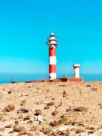 Lighthouse against clear blue sky