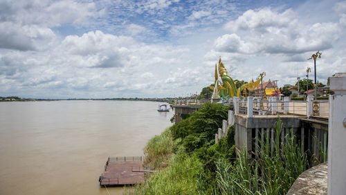 Scenic view of lake by building against sky