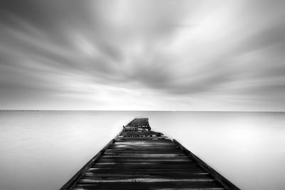 Pier over sea against sky