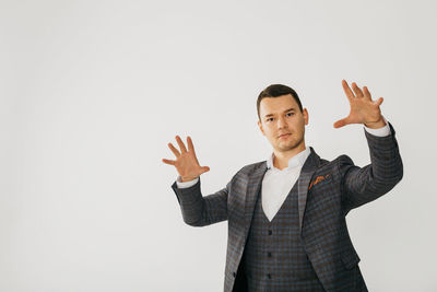 Portrait of mature man standing against white background