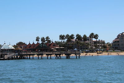 Calm sea against clear blue sky