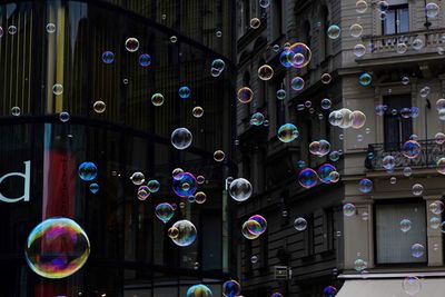 Close-up of bubbles flying against building