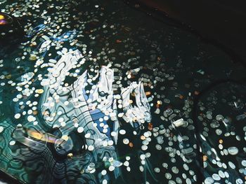 High angle view of coins in pond