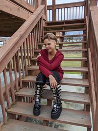 Portrait of young woman sitting on staircase