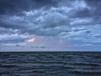 Scenic view of sea against cloudy sky