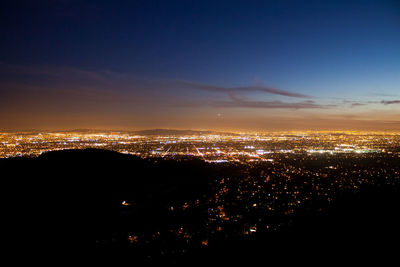 High angle view of illuminated buildings against sky at night