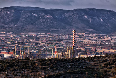 High angle view of buildings in city and industrial plant