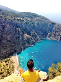 Rear view of man looking at sea