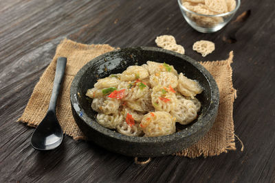 Seblak viral mamang rapael, stir fry raw crackers with chilli, garlic, and cikur aromatic ginger