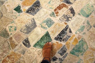 Close-up of person standing on tiled floor