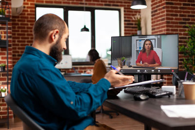 Businessman talking conference call at office