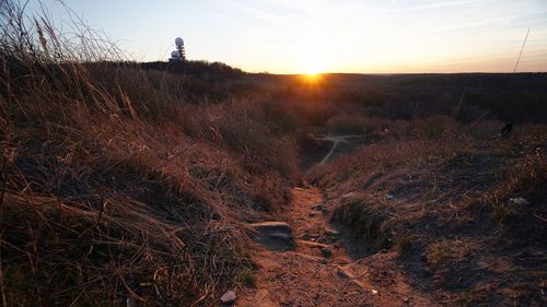 Scenic view of land against sky during sunset