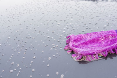 Close-up of wet purple towel on floor