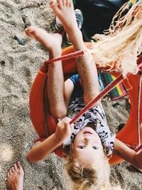 High angle portrait of mother and girl lying on land