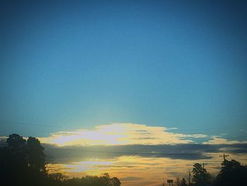 Silhouette trees against sky during sunset