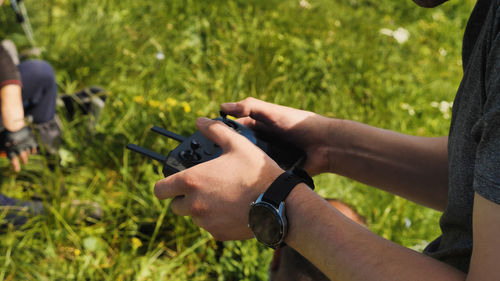 Close-up of the hands of the drone operator. a man is using a joystick to control a quadrocopter 