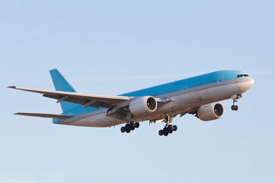 Low angle view of airplane against clear sky