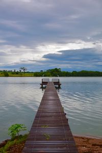 Pier over lake against sky