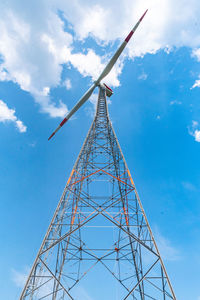 Low angle view of electricity wind mill against sky