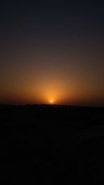 Scenic view of silhouette landscape against clear sky during sunset