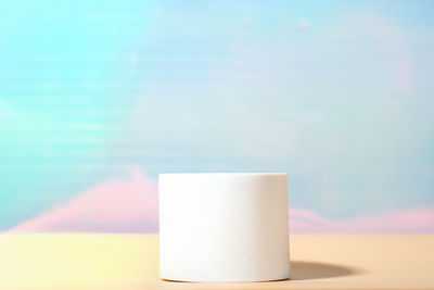 White geomertic podium on pastel yellow and blue background. mock up for product presentation, 