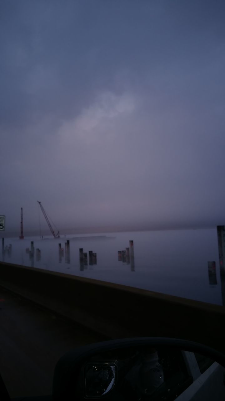 CLOSE-UP OF CARS ON SEA AGAINST SKY