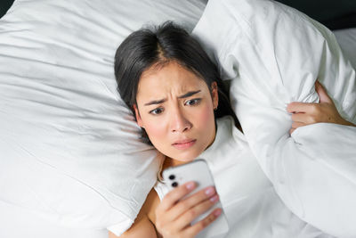 Young woman sleeping on bed at home