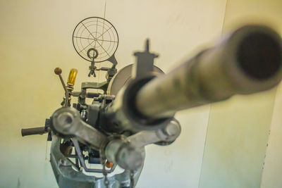 Close-up of machinery on table against wall