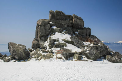 Stone wall against clear sky during winter