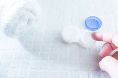 High angle view of human hand holding glass