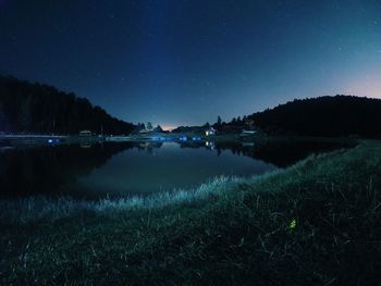 Scenic view of lake against clear sky at night