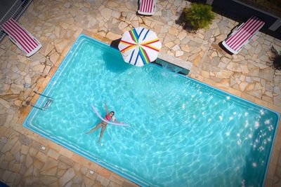 High angle view of girl swimming in pool